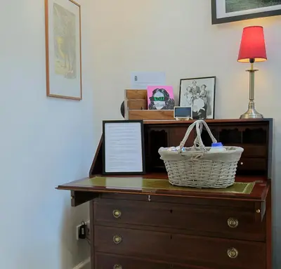 a wooden dresser with a basket on top of it at Pepper House Rooms - shared facilities - pet friendly in Ludlow