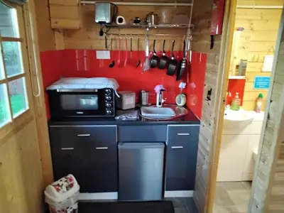 a small kitchen with a sink and a microwave at Alpaca Hideaway in Newtown