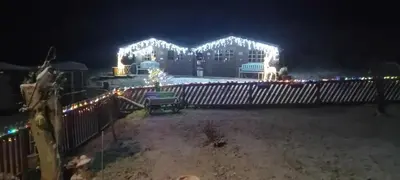 a house decorated with christmas lights at night at Alpaca Hideaway in Newtown