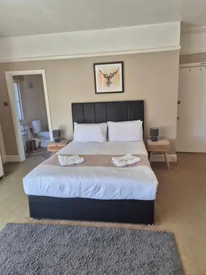 a bedroom with a large bed with two towels on it at The Stokesay Inn in Craven Arms