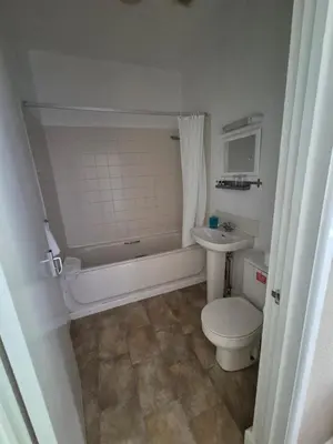 a bathroom with a tub and a toilet and a sink at The Stokesay Inn in Craven Arms