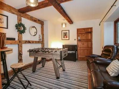 a living room with a ping pong table at Upper Home Farm in Church Stretton