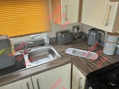 a kitchen with a sink and a counter top at Sunset Walk 046 in Barmouth