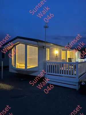 a mobile home is lit up at night at Sunset Walk 046 in Barmouth