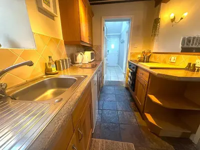 a kitchen with a sink and a counter top at Manteg in Aber-Arth
