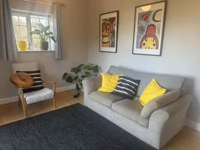 a living room with a couch and a chair at Manteg in Aber-Arth