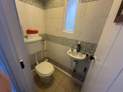 a small bathroom with a toilet and a sink at Manteg in Aber-Arth
