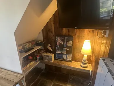 a lamp sitting on a shelf under the stairs at Manteg in Aber-Arth