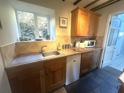 a kitchen with a sink and a microwave at Manteg in Aber-Arth