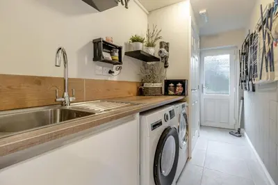 a kitchen with a sink and a washing machine at 3 Bed in Brithdir oc-c33971 in Llanfachreth