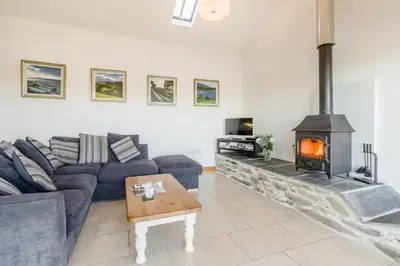 a living room with a couch and a fireplace at 1 Bed in Llangower oc-t34142 in Llangower
