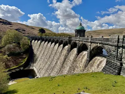 a dam on a river with a building in the background at 1 Bed in Cilmery oc-g32770 in Builth Road