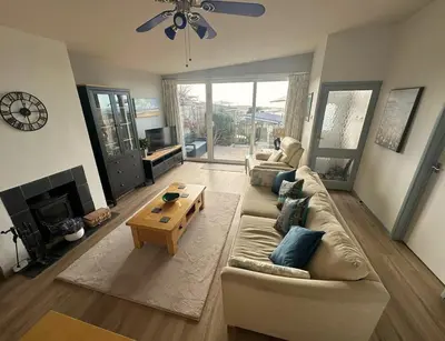 a living room with a couch and a table at Terrace by the Tide in Aberdyfi