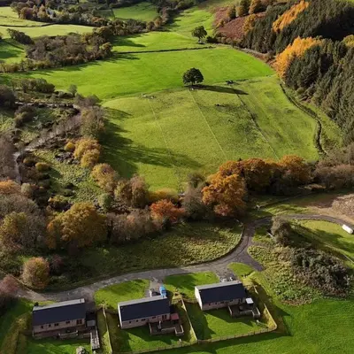 an aerial view of a farm with houses and trees at Deer Cabin-hot tub-dog friendly-mountain view in Llanbrynmair