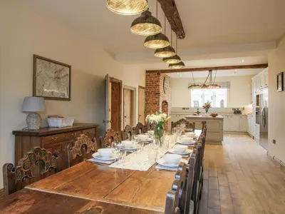 a dining room with a long table and chairs at Highfields Farm in Church Stretton