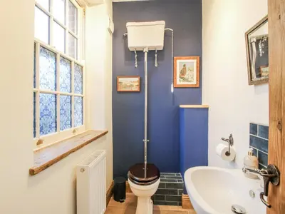 a bathroom with a toilet and a sink at Highfields Farm in Church Stretton