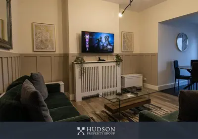 a living room with two couches and a flat screen tv at Modern 5 Bedroom Home in Shrewsbury in Shrewsbury
