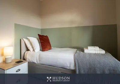 a bedroom with a bed with red pillows on it at Modern 5 Bedroom Home in Shrewsbury in Shrewsbury