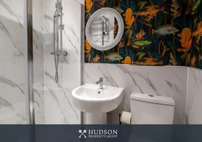 a bathroom with a sink and a toilet and a mirror at Modern 5 Bedroom Home in Shrewsbury in Shrewsbury