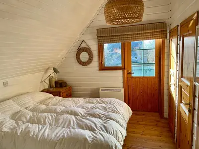 a bedroom with a bed and a window and a door at Luxurious lodge near Barmouth in Dyffryn