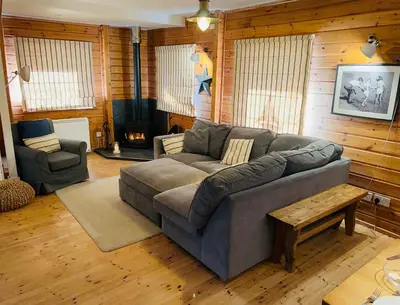 a living room with a couch and a chair at Luxurious lodge near Barmouth in Dyffryn