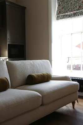 a couch with two pillows sitting in a living room at Luxury Apartment in Shropshire sleeps 6 in Shrewsbury