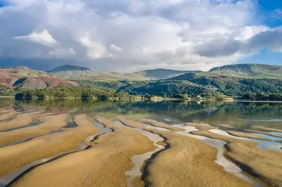 a body of water with mountains in the background at Hywel-Sele-Lodge in Llanfachreth