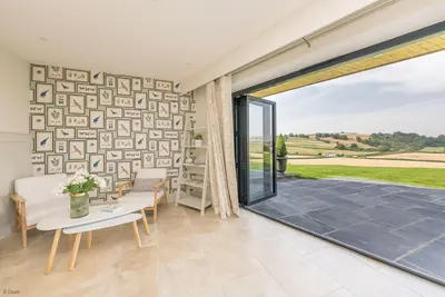 a living room with a large sliding glass door at Llety-Cariad in Montgomery