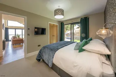 a bedroom with a large bed and a window at Llety-Cariad in Montgomery