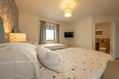 a bedroom with two beds and a window at Llety-Bugail in Montgomery