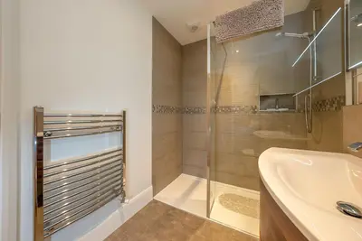 a bathroom with a shower and a sink and a tub at Llety-Bugail in Montgomery