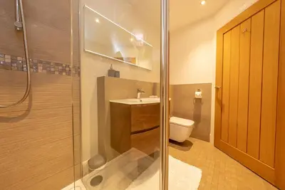 a bathroom with a shower and a sink and a toilet at Llety-Hiraeth in Montgomery