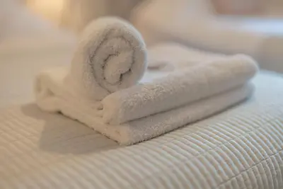 a stack of towels sitting on top of a bed at Llety-Hiraeth in Montgomery