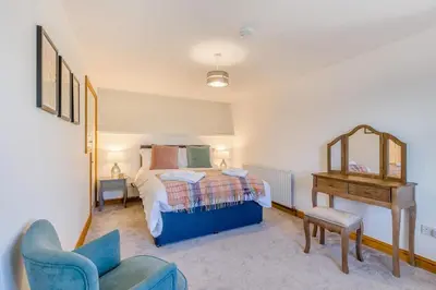 a bedroom with a bed and a mirror and a desk at 3 Bed in Rhydyfelin oc-c34178 in Rhyd-y-felin
