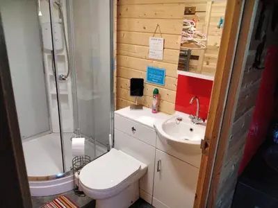 a small bathroom with a toilet and a sink at Moonlight View in Newtown