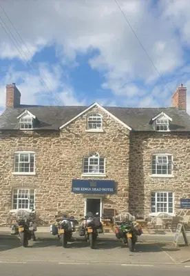 a group of motorcycles parked in front of a brick building at The Kings Head, Meifod in Meifod