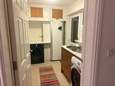 a small kitchen with a washer and dryer in it at Swn yr Coed in Sennybridge