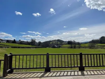 a park bench overlooking a field of green grass at Swn yr Coed in Sennybridge