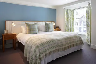 a bedroom with a large bed and a window at Y Meirionnydd Boutique Hotel in Dolgellau
