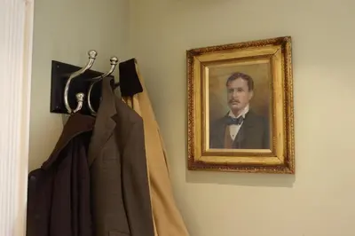 a picture of a man in a suit hanging on a wall at Y Meirionnydd Boutique Hotel in Dolgellau