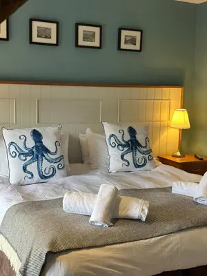 a large bed with two octopus pillows on it at Y Meirionnydd Boutique Hotel in Dolgellau