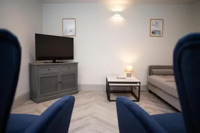 a living room with a flat screen tv and a couch at Dolphin View New Quay in New Quay