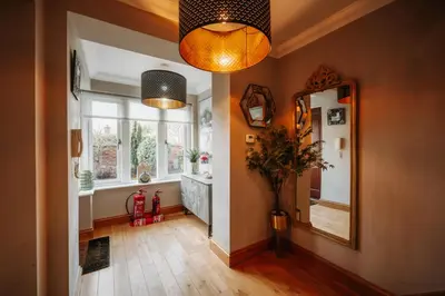 a hallway of a home with a mirror and a mirror at Cherry Tree House in Shrewsbury