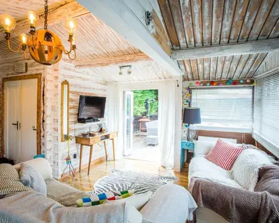 a living room with two couches and a tv at Wunder Lodge - Snowdonia Log Cabin in Trawsfynydd