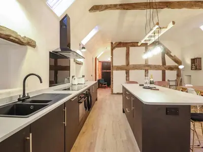 a kitchen with a sink and a counter top at Godre'r Gyrn, Plas Moelfre Hall Barns in Oswestry