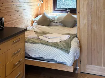 a unmade bed in a room with a wooden wall at The Orchard - Ukc7804 in Shrewsbury