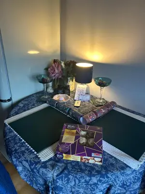 a table in a room with a table with a lamp at The Cwtch in Ludlow
