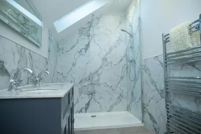 a bathroom with a shower and a sink at Gelli Genlas Aberaeron in Llanarth