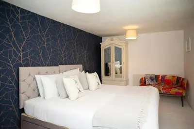 a bedroom with a large bed with white pillows at 5 Rock Street New Quay in New Quay