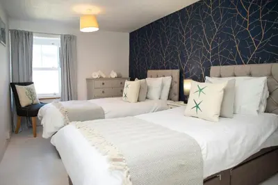 a bedroom with two beds with white sheets at 5 Rock Street New Quay in New Quay